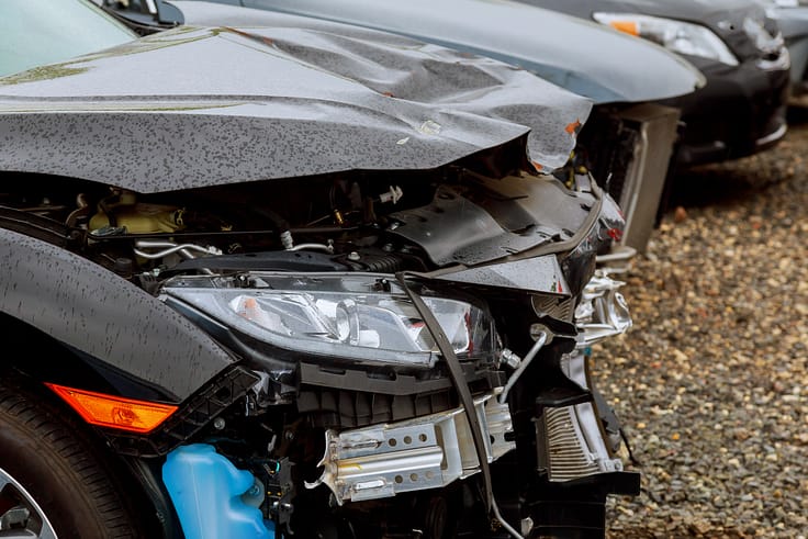 A scene of two wrecked cars after a collision on a busy city street in Atlanta, Georgia.