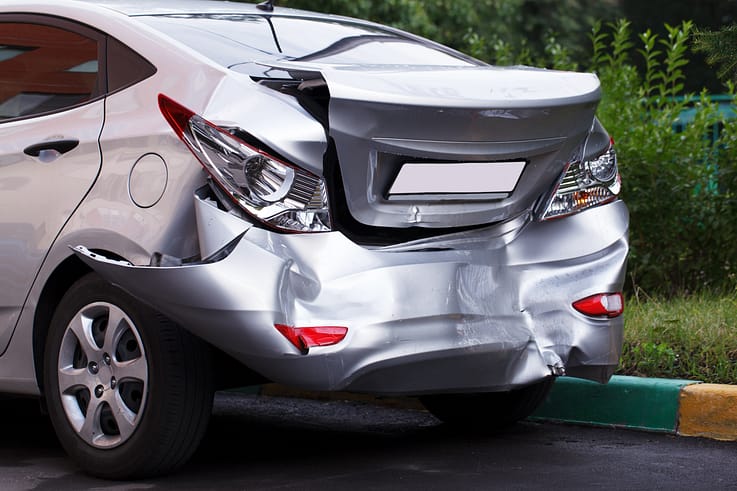 A car with a large dent on the side, showcasing the damage caused by a collision.