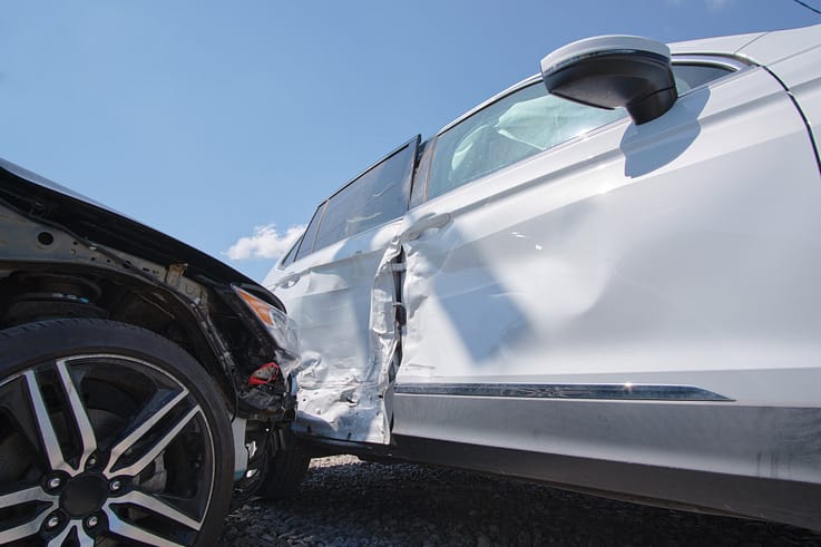 Two cars involved in a serious collision on a city street, highlighting the need for preventative measures.