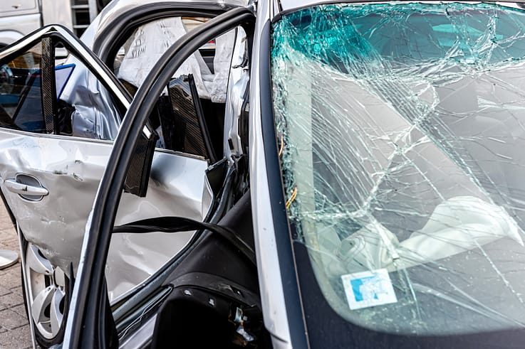 A close-up of a damaged vehicle after a heavy crash, revealing the intricate details of the collision.